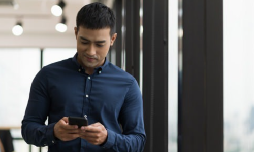 lifestyle image of a man on his smart phone outdoors